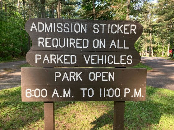 a brown park sticker sign at a state park