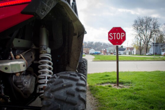 close up of atv on road stopped at stop sign