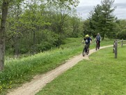 Two mountain bikers on a trail in the woods