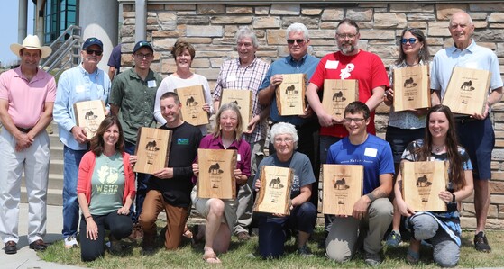 Recipients of the 2023 Invader Crusader Awards stand with their plaques at the annual awards ceremony held at Horicon Marsh on June 7, 2023. 