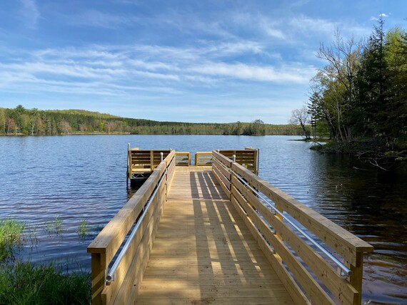 Accessible wooden fishing pier jutting out over lake
