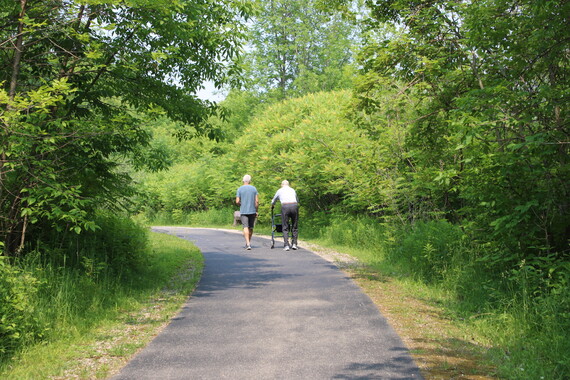 Two people enjoy a walk on a universally accessible trail