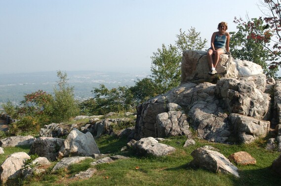 Person on a rock overlooking wide open landscape