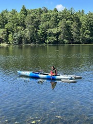 Person in an adaptive kayak paddling in a lake