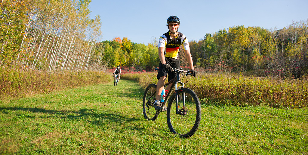 Person on mountain bike on grassy trail in the fall at Kettle Moraine State Forest