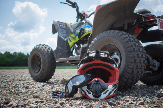 helmet on ground in front of ATV