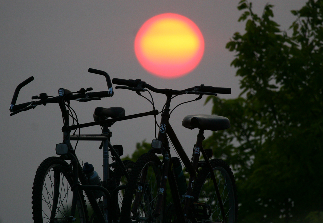 Silhouette of bikes against moon
