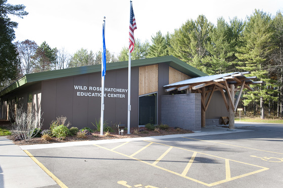 A brown building with a green roof, which houses the Wild Rose Fish Hatchery. 