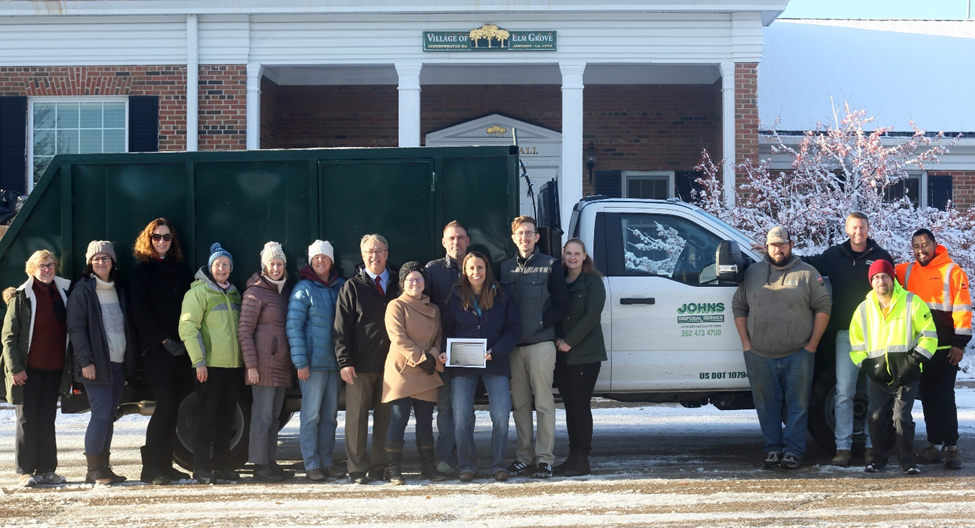 elm grove green team members stand in front of recycling truck