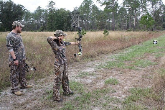 female youth hunter wearing camo using a crossbow