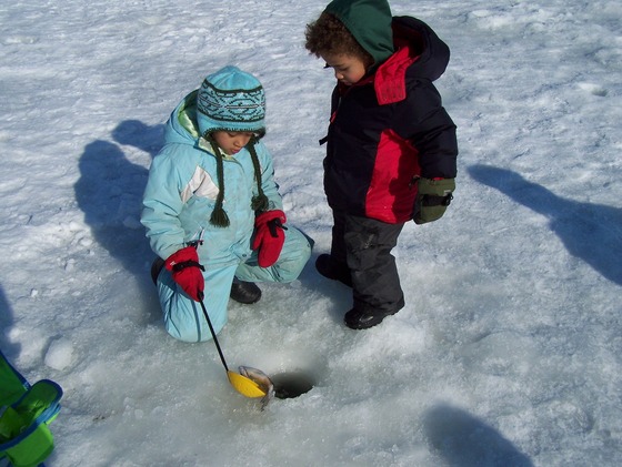 Kids ice fishing in winter gear