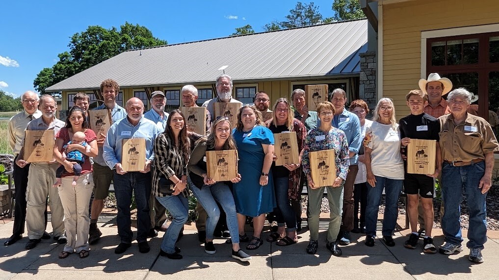 Recipients of the 2024 Invader Crusader Awards stand with plaques at the awards ceremony held at Necedah National Wildlife Refuge on June 5, 2024