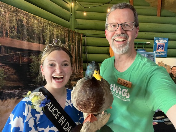 A man and Woman stand at the Wisconsin State Fair DNR Booth