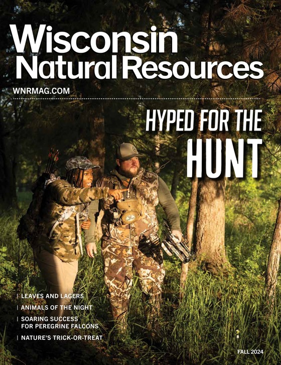 cover of fall WNR magazine showing a man and woman in camo pointing off in the distance