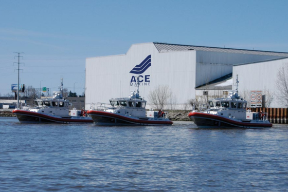 The outside of the Fincantieri ACE Marine building is shown beside a waterbody with boats docked. 