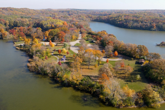 An aerial view of land at the Pike Lake Unit of Kettle Moraine State Forest in the fall, with brilliant foliage. 