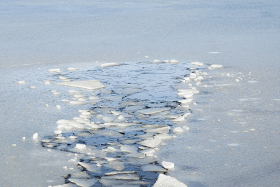 Partially thawed ice covers a lake.