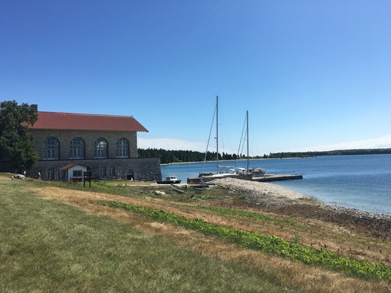 Building with lake and grass in background.