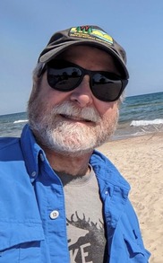 A selfie of an individual wearing sunglasses and a baseball cap.