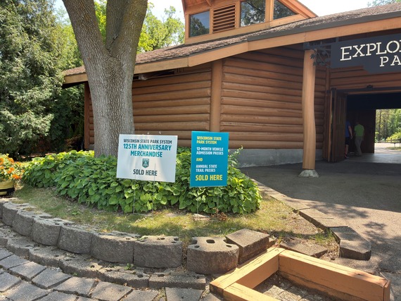 Exterior of DNR Cabin with two signs in grass