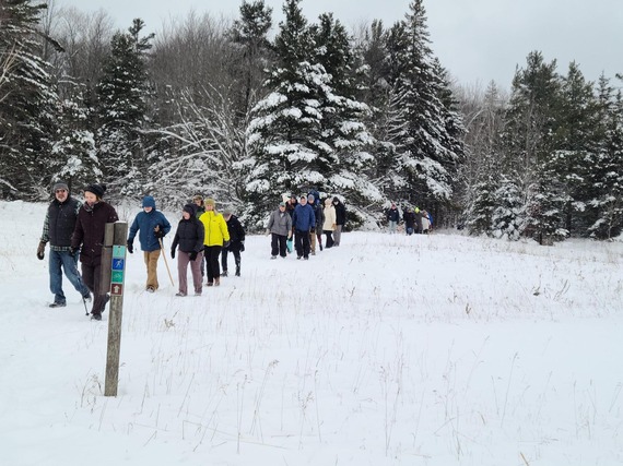 People walking in the snow inline.