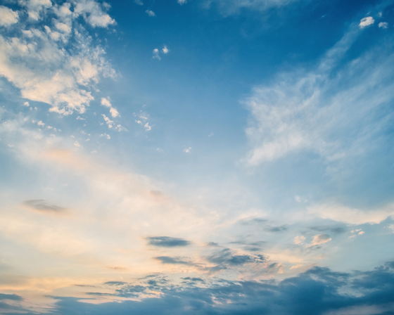 Blue sky with white clouds at sunrise. 