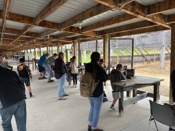 people lined up shooting at the McMiller Shooting Range