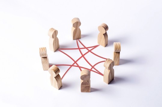 Wooden Figurines connected by red lines