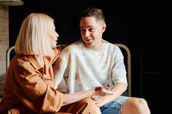 Adult female talking to a teenage male