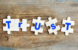 Puzzle pieces spelling the word Trust