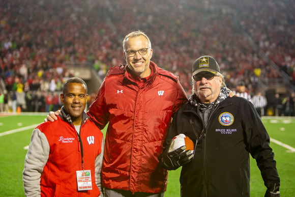 On Wisconsin Salute to Veterans Tailgate and Honorary Game Ball - Sec Bond UW Athl Director Chris McIntosh and Bruce Wilber C/TVSO 11.16.24