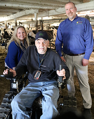 Amy Pechacek, left, and Randy Romanski, right, meet with farmer Darrel Jones to learn more about his use of assistive technology.