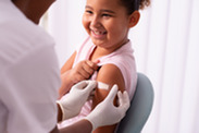 Smiling child with bandage on arm