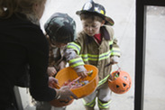Trick or treat Fireman and soldier getting candy from bowl