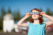 Girl wearing eclipse glasses