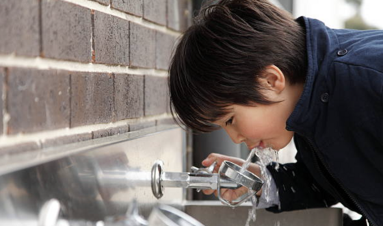 Boy Drinks From Water Fountain