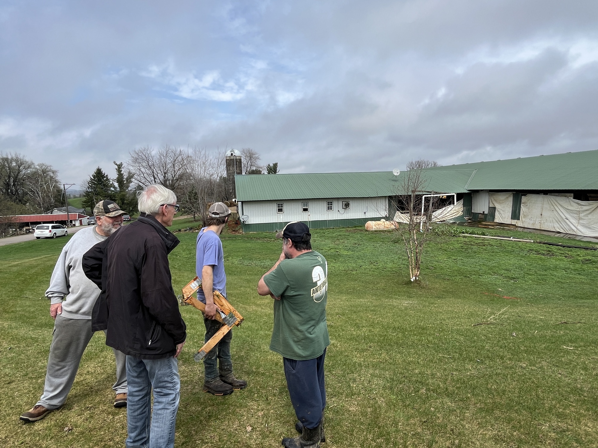 Gov. Evers talks to farmers near damaged barn