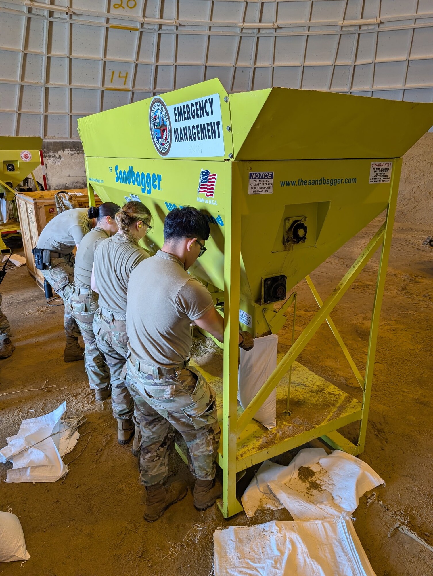 Wisconsin National Guard members pack sandbags.