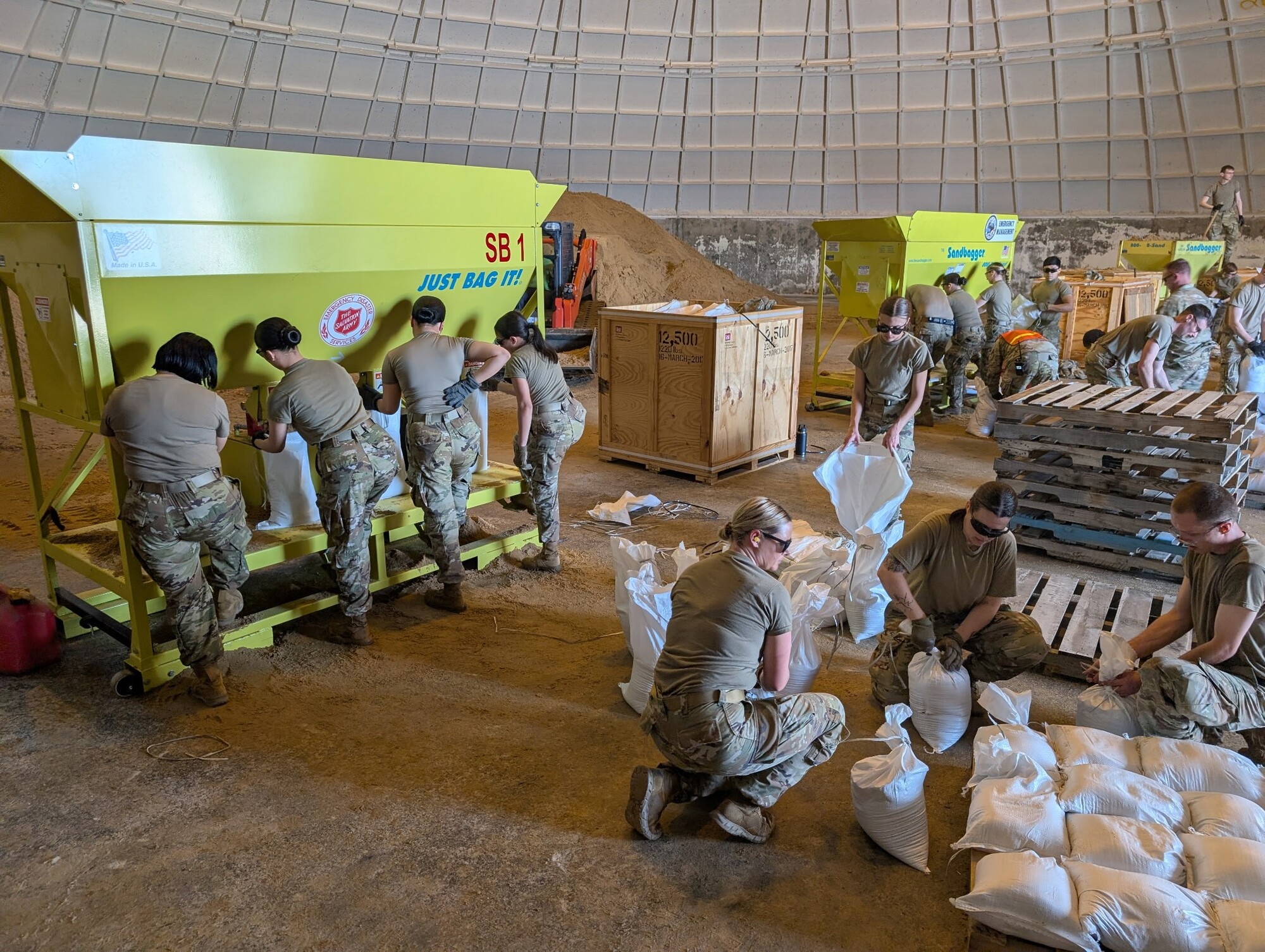 Wisconsin National Guard members pack sandbags. 
