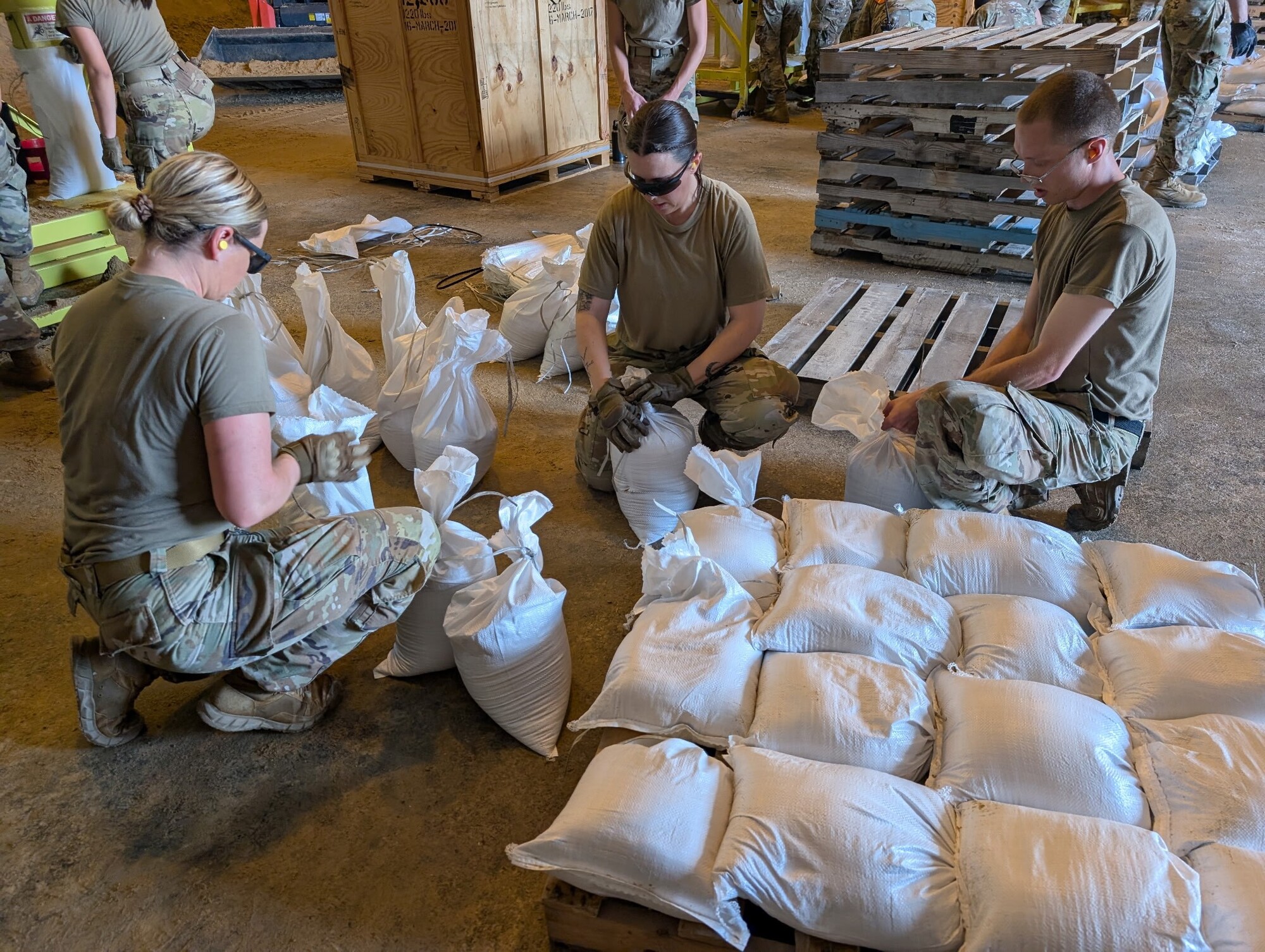 Wisconsin National Guard members pack sandbags.
