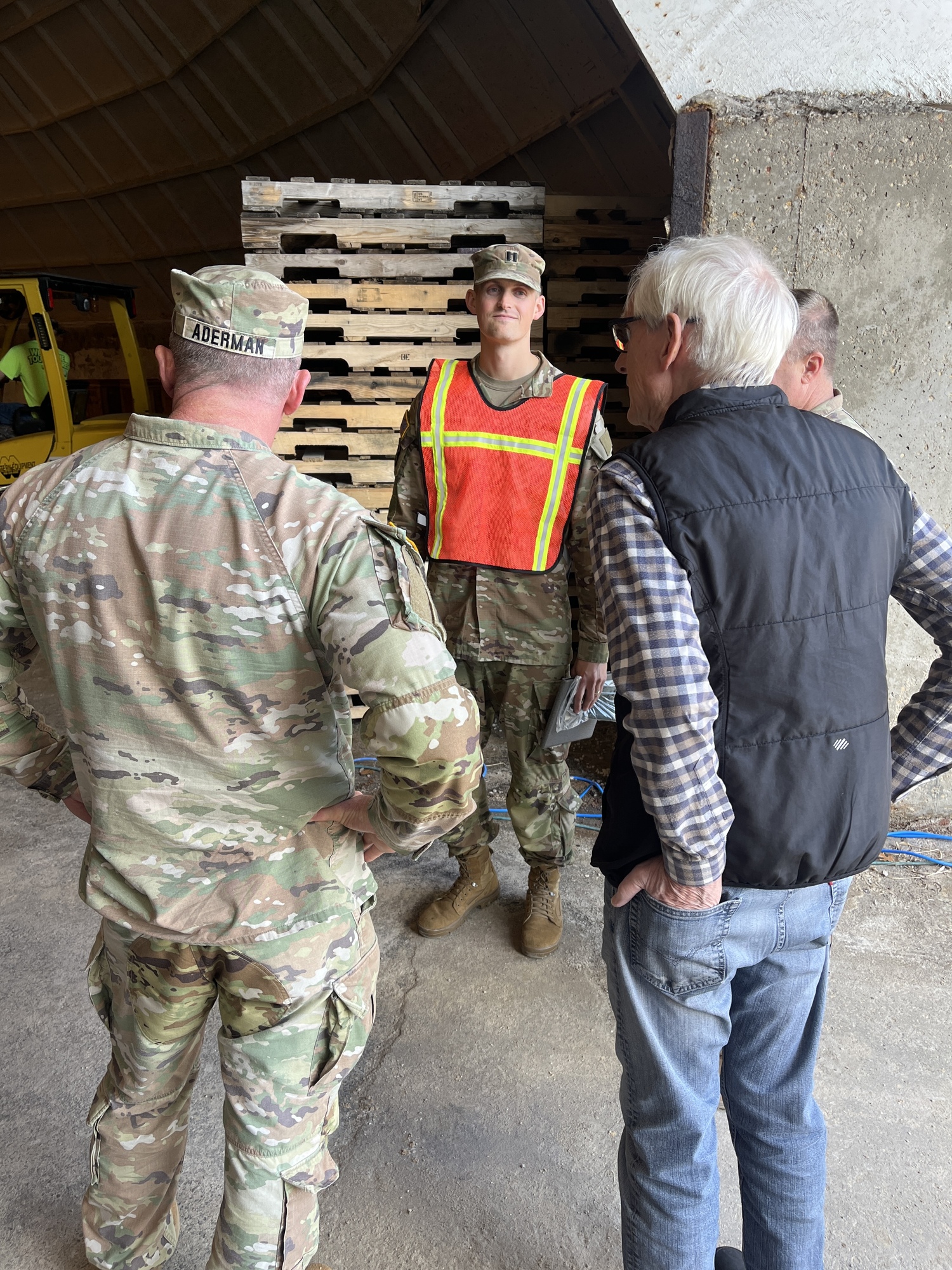 Governor Evers speaks to two Wisconsin National Guard members. 