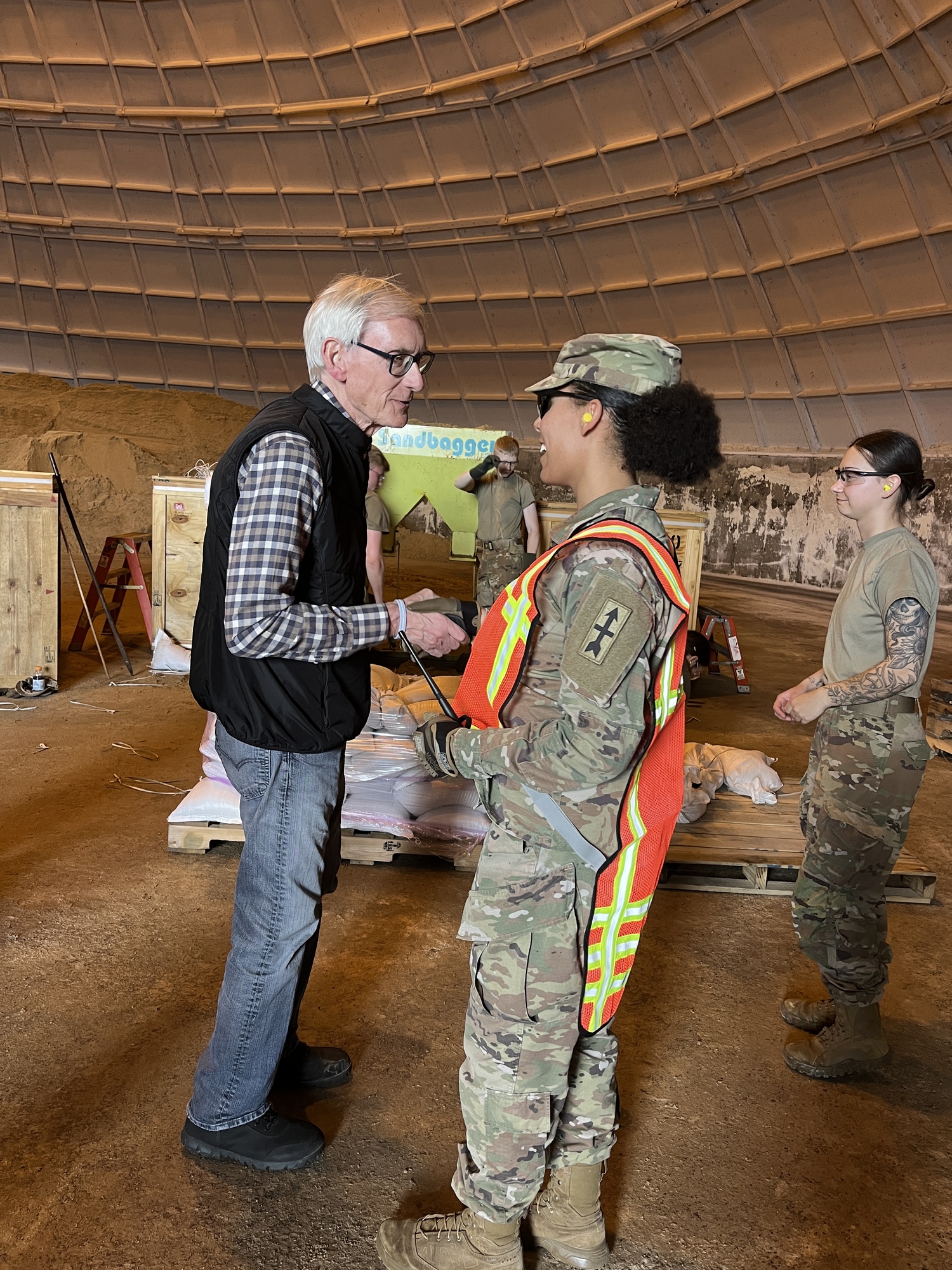 Governor Evers shakes hands with a Wisconsin National Guard member. 