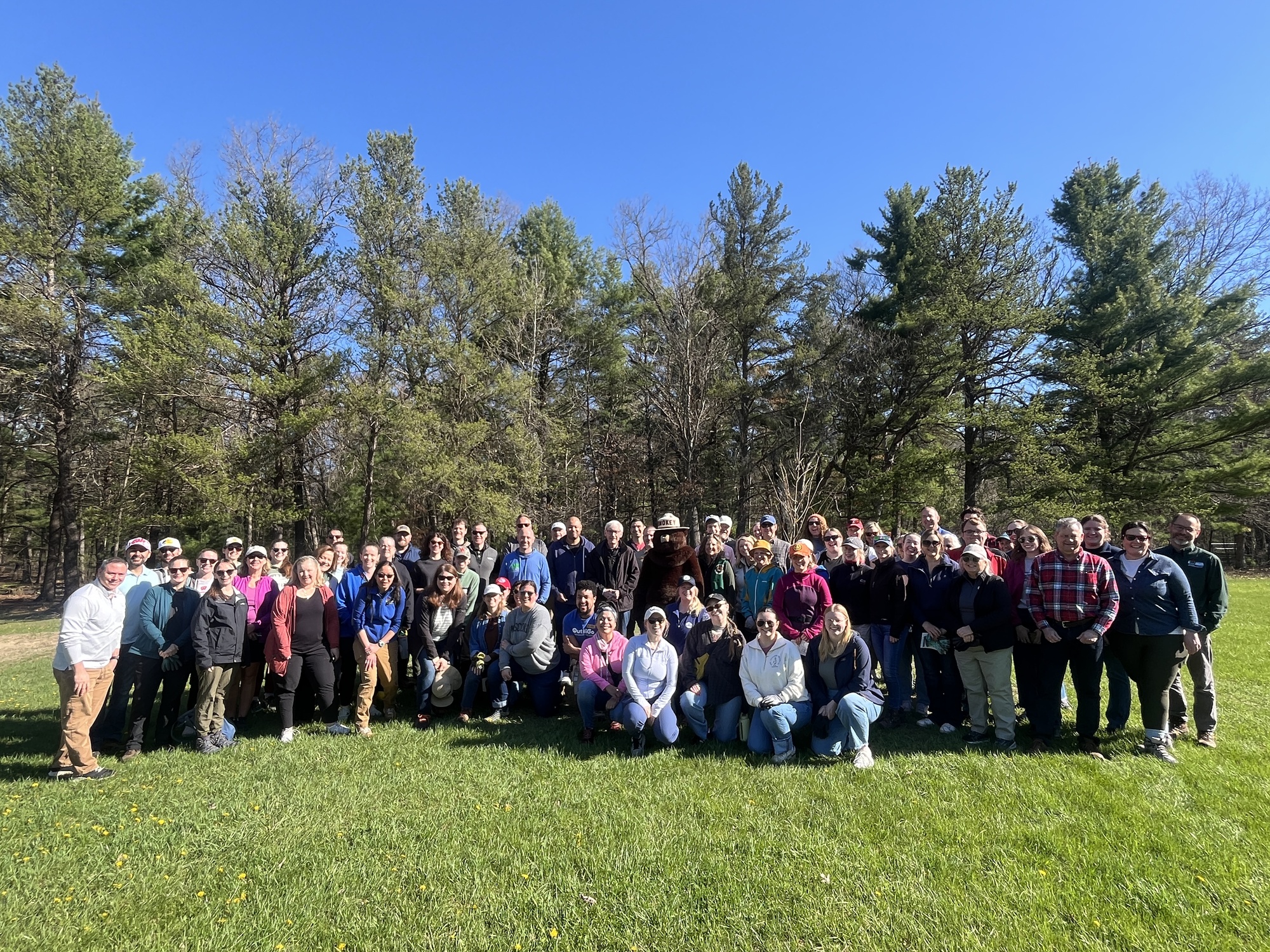 Evers Administration group photo with Smokey the Bear at the annual Earth Day of Service at Mirror Lake State Park.
