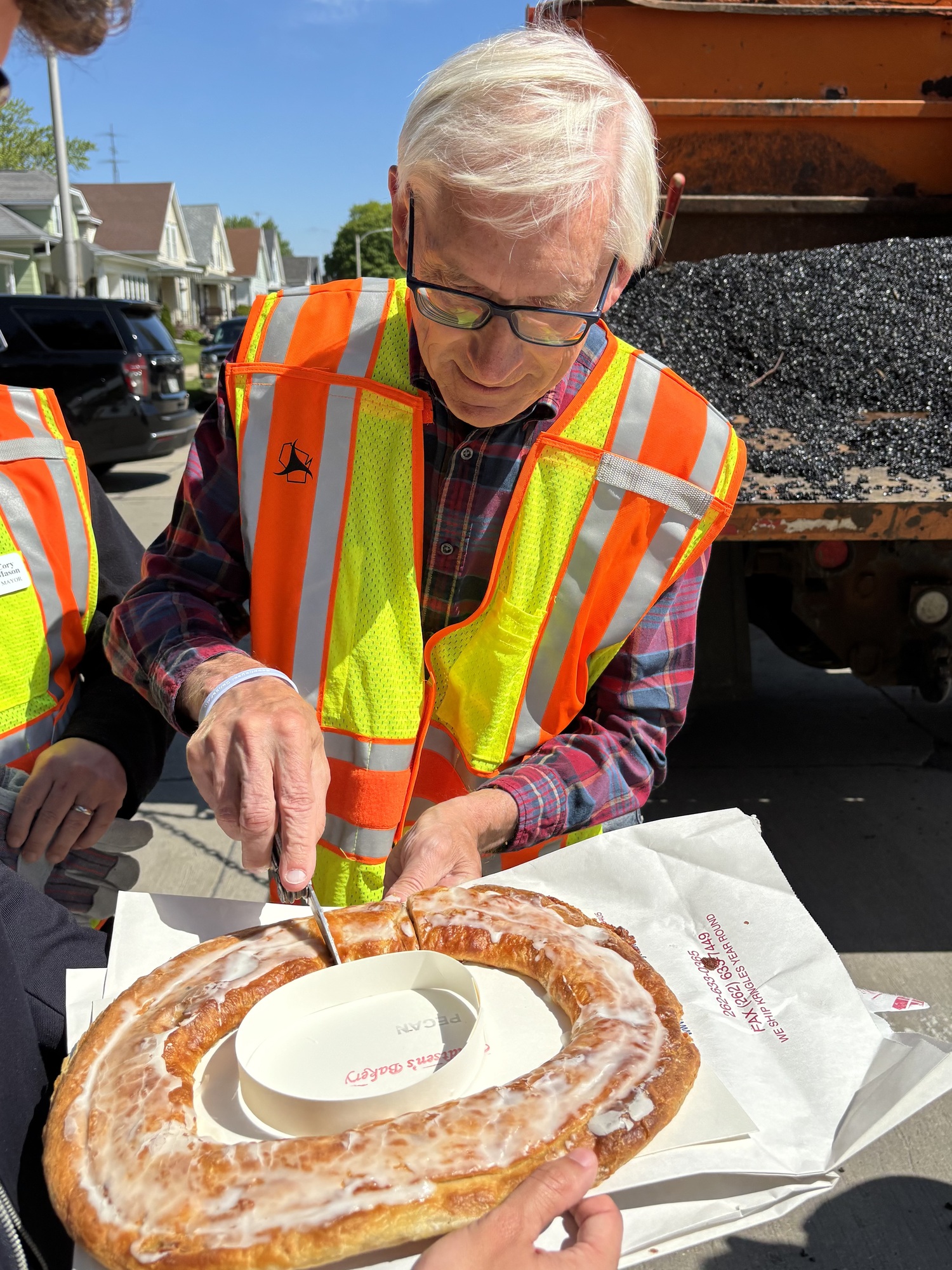 Gov. Evers enjoys a Kringle while out on Pothole Patrol in 2025.