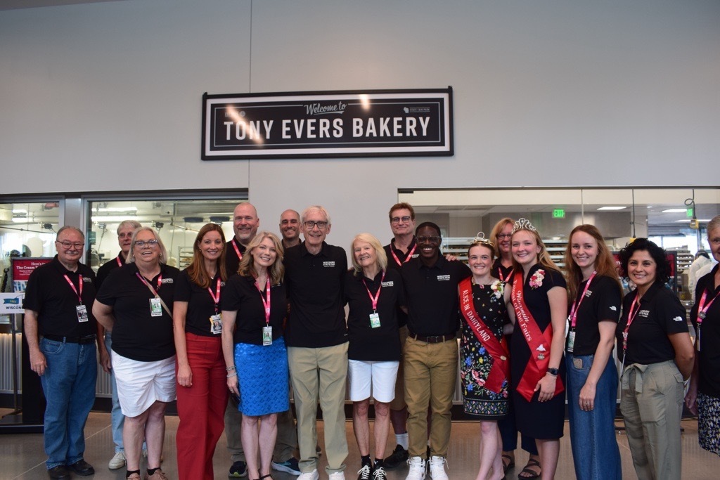 Gov. Evers poses for a group photo with local leaders and friends at the new Tony Evers Bakery at State Fair Park.