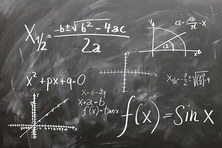 Image of math formulas on a black chalkboard