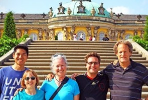 Teachers posing in front of a domed building in Germany