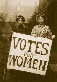 Two women from the 19th century holding a sign that reads, "Votes for Women"