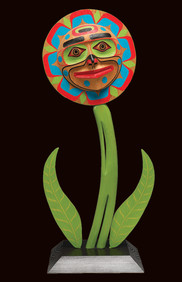 Image of Native flower topped with a traditional sun image and face, typical of the Kwaguilth Tribe