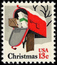 U.S. postage stamp featuring  painting of rural mailbox with door opened to show packages inside and the words Christmas and 13 cents